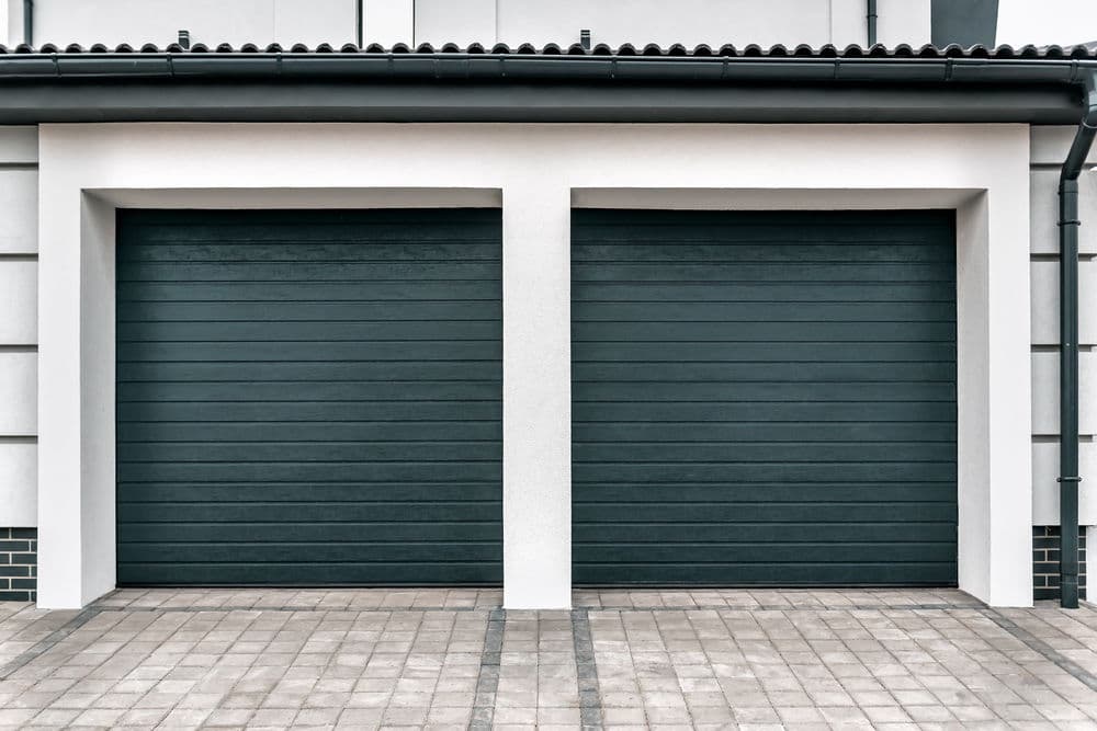 Two modern garage doors with horizontal slats, set against a minimalist architectural backdrop.