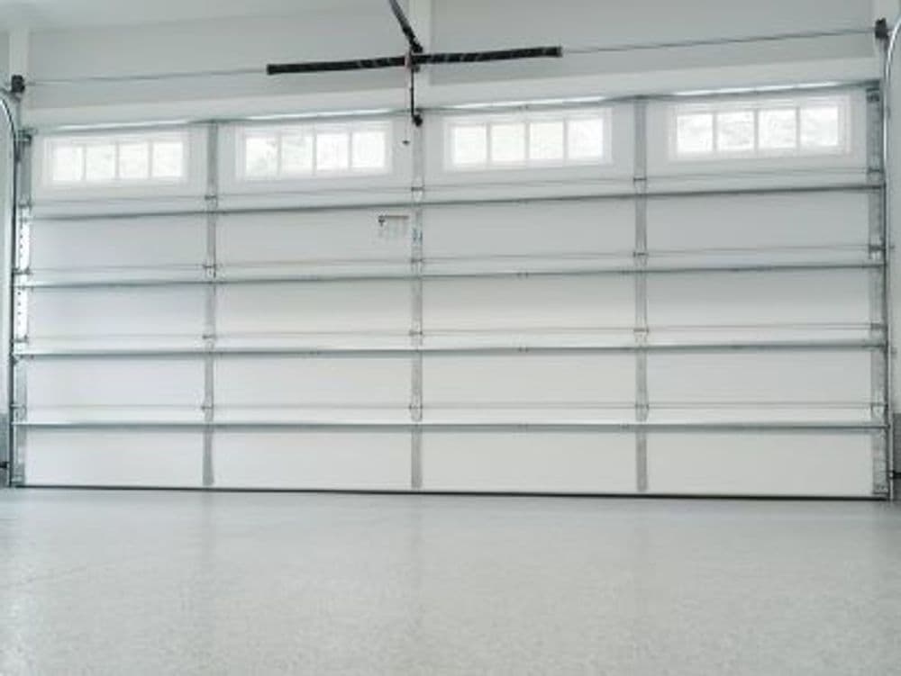 Clean and spacious garage interior with large overhead door and bright natural light.